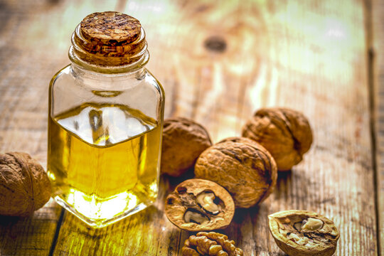 cosmetic and therapeutic walnut oil on wooden background