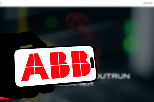Kiel, Germany - 08-19-2026: Smartphone displaying Swiss-Swedish industrial technology company ABB Group logo in front of companys webpage