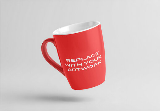 Ceramic mug mockup with white interior and handle, angled view floating against a neutral gray background, realistic product presentation for branding, graphic design, or print display