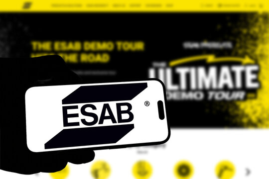 Kiel, Germany - 08-19-2026: Smartphone displaying US welding equipment manufacturer ESAB logo in front of companys webpage