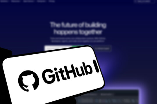 Kiel, Germany - 08-19-2026: Smartphone displaying US code hosting platform GitHub logo in front of companys webpage