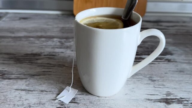 Hot Tea with Lemon Slice in White Mug