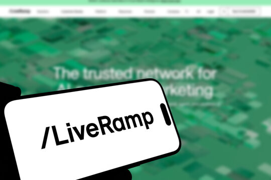 Kiel, Germany - 08-19-2026: Smartphone displaying US data collaboration software company LiveRamp logo in front of companys webpage