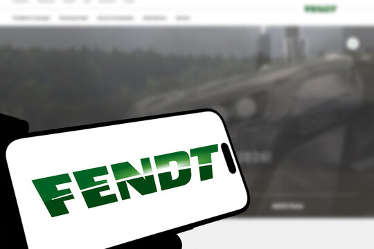 Kiel, Germany - 08-19-2026: Smartphone displaying German agricultural machinery brand Fendt logo in front of companys webpage