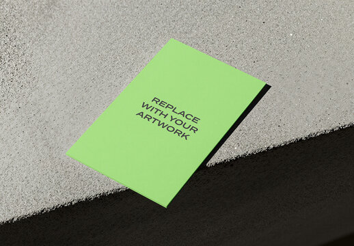 Brochure mockup on a textured concrete surface with dark asphalt edge, horizontal flat lay presentation for graphic design, branding, and editorial display, template