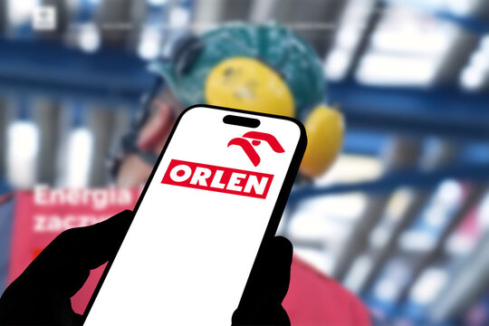 Kiel, Germany - 08-19-2026: Smartphone displaying Polish energy company ORLEN logo in front of companys webpage