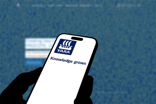 Kiel, Germany - 08-19-2026: Smartphone displaying Norwegian agricultural chemicals company Yara International logo in front of companys webpage