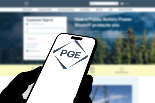 Kiel, Germany - 08-19-2026: Smartphone displaying US electric utility company Portland General logo in front of companys webpage