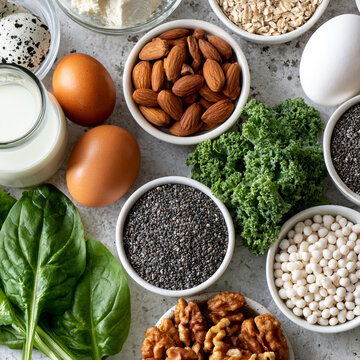 Assorted healthy keto diet ingredients featuring eggs nuts seeds cheese and greens