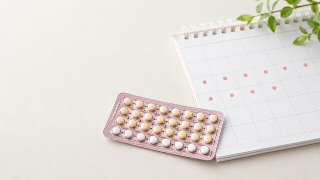 A Close-Up of a Birth Control Pill Pack Next to a Calendar, Illustrating Medical Planning and Reproductive Health Choices
