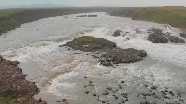 Panoramic aerial view of Urridafoss waterfall under cloudy