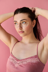 Fototapeta premium Charming young woman enhances her beauty with a cozy vibe in a playful setting.