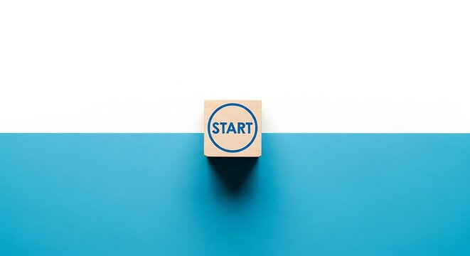Minimalist wooden block with start text, beginning concept on blue and white background, business launch and career initiation