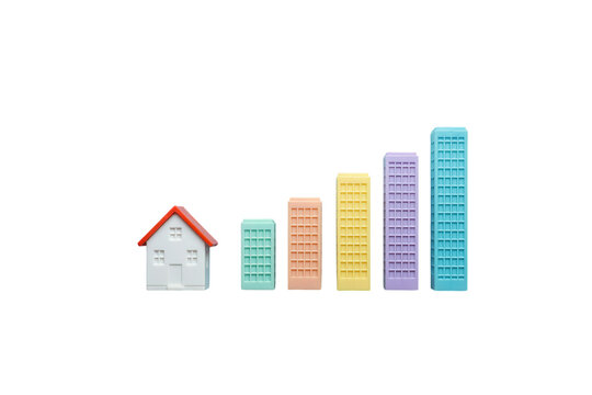 Real estate investment growth depicted by a house and building blocks forming an upward trend graph on a white background