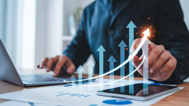 Professional financial analyst using a laptop to monitor rising market growth trends and economic success through digital business data analysis