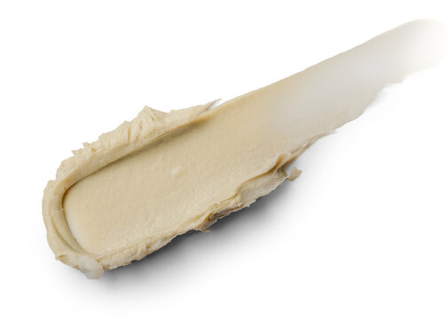 Creamy paste spreads smoothly across a clean white surface. Ideal for beauty, skincare visuals