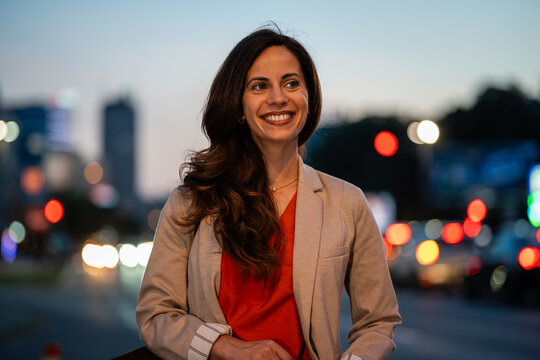 Successful woman smiling looking away in urban setting