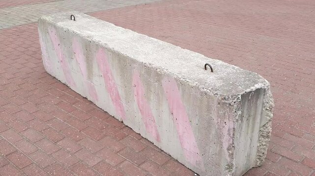 A concrete block for cordoning off an area at an event. A reinforced concrete block for blocking traffic or creating a barrier.