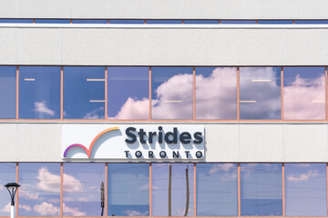 Fototapeta premium Toronto, ON, Canada - August 17, 2026: Strides Toronto logo and sign on the clinic building in Scarborough, Toronto, ON, Canada. Eglinton Strides Toronto is a multi-service community agency that provi