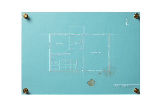 Architectural blueprint of a modern house interior design plan on blue paper sheet with brass corner fasteners isolated on white background