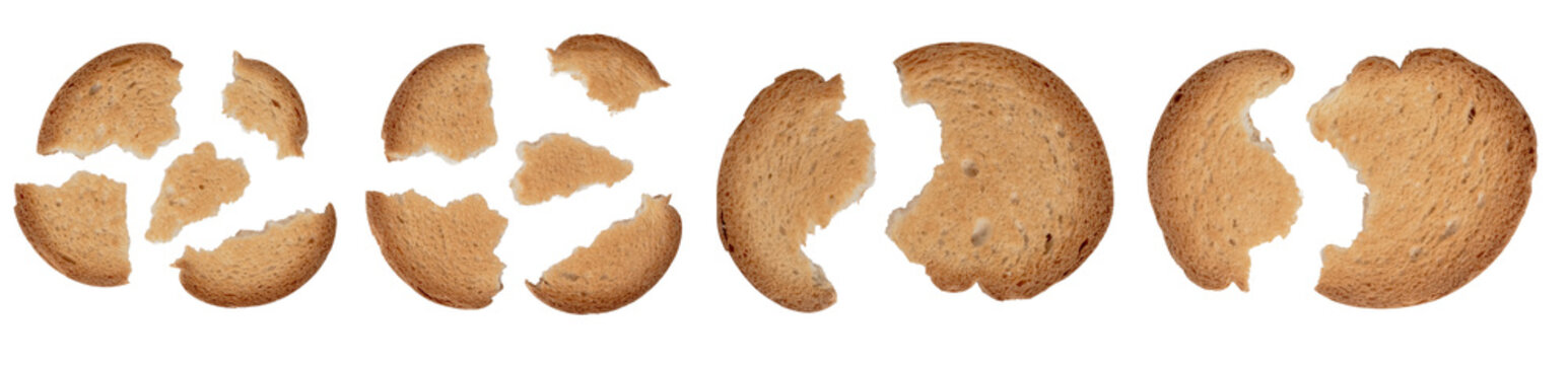 A collection set of broken pieces and cracked slices of golden brown toasted bread or rusks, showing porous textures and crispy crusts viewed from above, isolated on a transparent background.