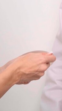 Doctor demonstrating silicone breast implant options during consultation, plastic surgery marketing, healthcare provider, aesthetic medicine.