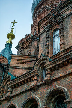Upper brick towers and green onion domes of historic Saint Sophia Cathedral in Harbin Heilongjiang China