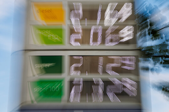 Abstract zoom blur shot of gas station price board displaying high fuel prices, energy crisis and inflation concept