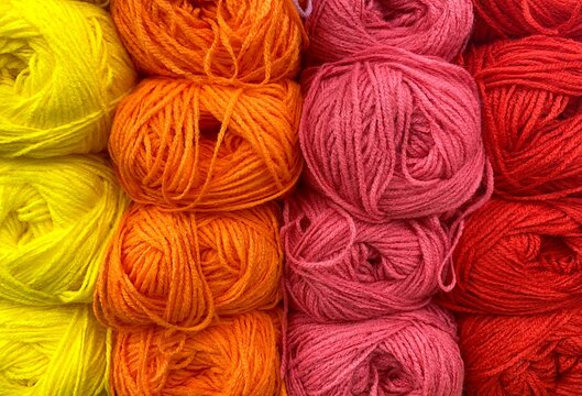 There are many balls of yarn for knitting on the shelf, in different colors. It&rsquo;s a beautiful, bright photo handmade, a hobby