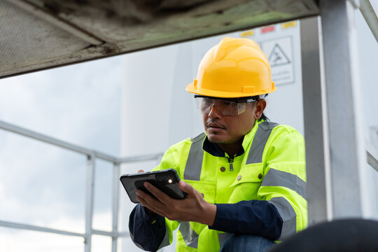 Industrial technician using a smartphone during equipment inspection, representing digital maintenance, field diagnostics, asset monitoring, workplace safety and modern engineering service technology.
