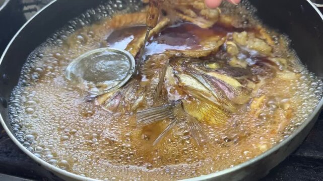 Chef's Spoon Clearing Foam from Fish in Boiling Soy Sauce Broth: Japanese Sea Bream Nimono at an Izakaya