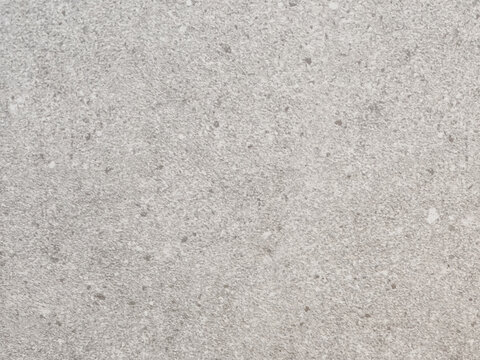 High-resolution flat lay of a fine speckled stone and terrazzo texture background with natural gray and white flecks. Target audience includes interior designers, 3D surface mappers, graphic designers