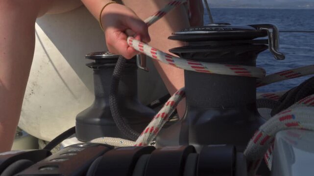 Sailor trimming sail with a winch