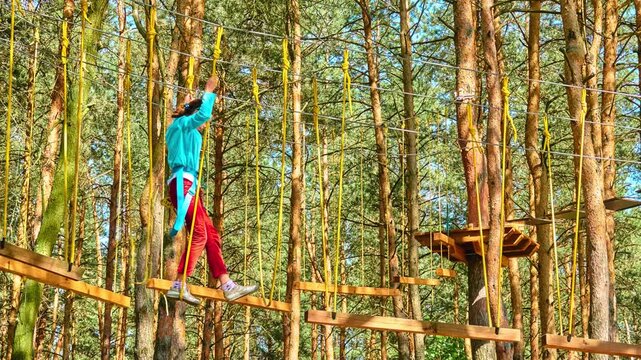 Girl climbing in adventure park
