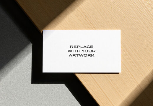 Business card mockup on a wooden surface with natural light, horizontal flat lay presentation, realistic stationery branding template for graphic design and print