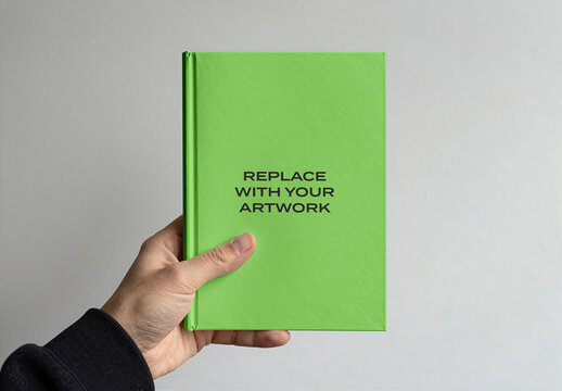 Book cover mockup held in hand against neutral background, realistic presentation of printed artwork for branding and design display, template publishing purposes