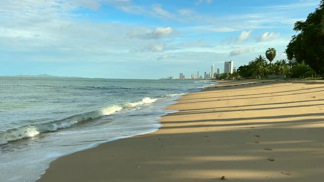 Slow panning shot of beautiful morning beach with bright sky