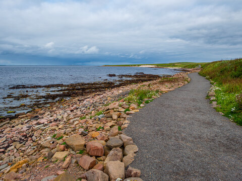 The rocky Scottish shoreline at John o' Groats, overlooking Pentland Firth in Caithness, which tourists mistakenly regard as the most northern point of Great Britain.
