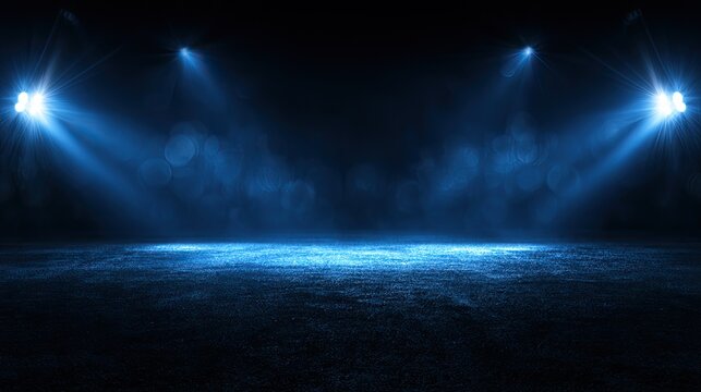 Dark arena illuminated by blue spotlights with hazy atmosphere
