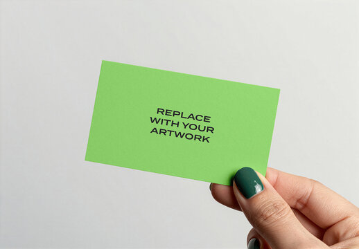 Business card mockup held in hand against plain white background, realistic stationery presentation with placeholder text for artwork replacement, vertical orientation, close-up product display