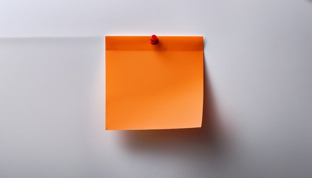 single orange sticky note attached to a plain white wall with reminder adhesive