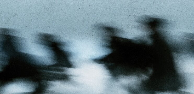 Silhouettes of figures blur in a monochromatic, atmospheric haze