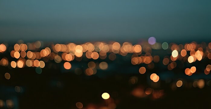 Softly blurred city lights twinkle against a dark twilight sky