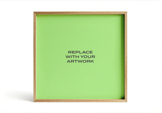 Framed vertical poster mockup with a square wooden frame displayed on white surface in an interior studio setting, green background for artwork presentation, minimalist design, printable template