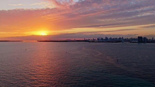 Sea sunset horizon. Sunset cloudy sky. Seascape at summer vacation. Skyscape with sea horizon. Horizon sunrise sea with ship. Sunrise seascape. Romantic summer vacation Miami seascape