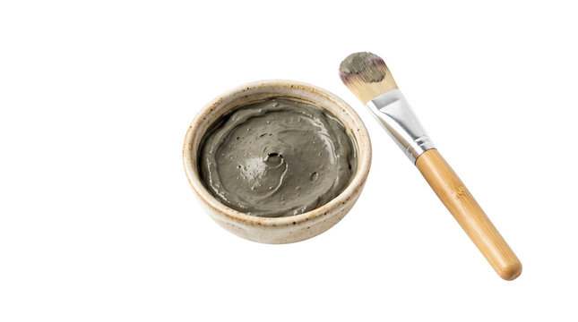 Natural bentonite clay face mask in ceramic bowl, organic charcoal mud mask with applicator brush, skincare spa treatment isolated PNG with Transparent Background