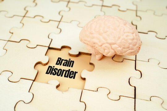 Brain disorder concept with human brain model and puzzle pieces, representing neurological disease, cognitive impairment, mental health, neuroscience and brain dysfunction.