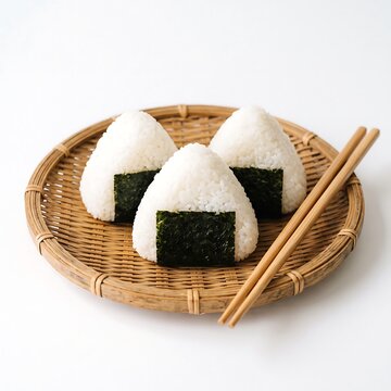 Three japanese rice balls on a bamboo tray isolated on white background