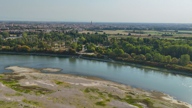Po river displaying significant low water levels and extensive dry banks near Cremona. Lombardy