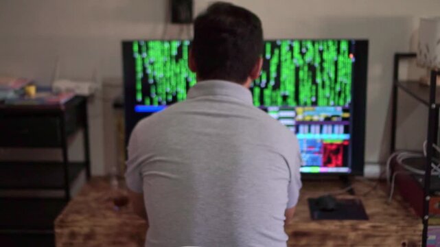 Unrecognizable man monitoring hacker terminal interface, glowing code screens, cybersecurity, hacking and digital crime concept.